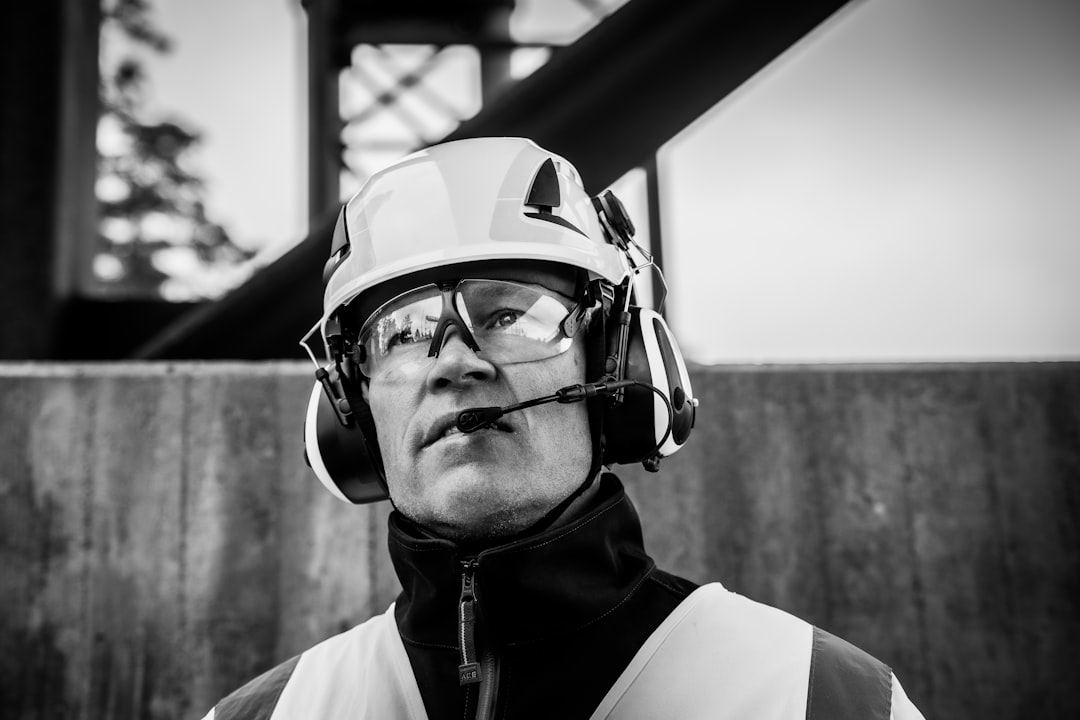 Construction worker wearing a safety helmet and hearing protection as an example of job-specific PPE.