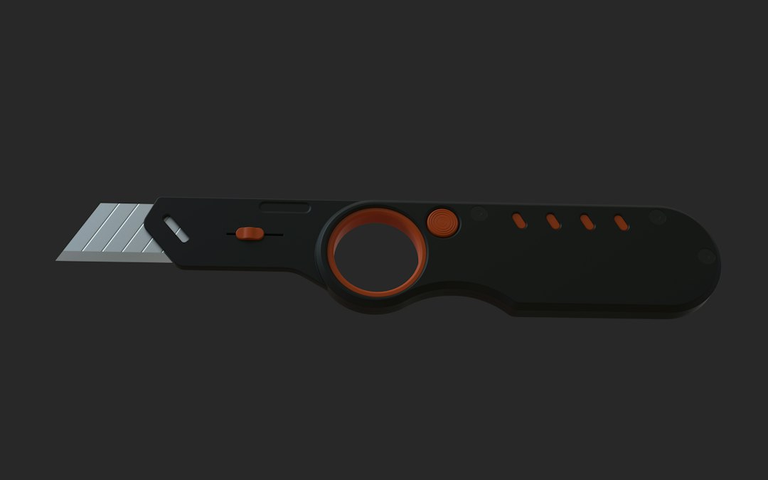 Folding utility knife with orange accents on a plain background