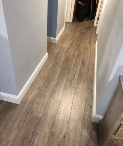 Installed hardwood flooring in a residential hallway