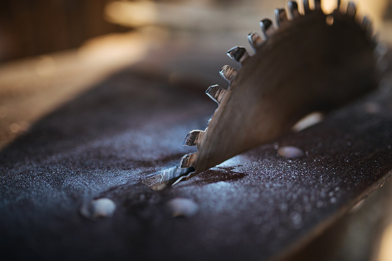 Circular saw blade cutting through wood in a workshop